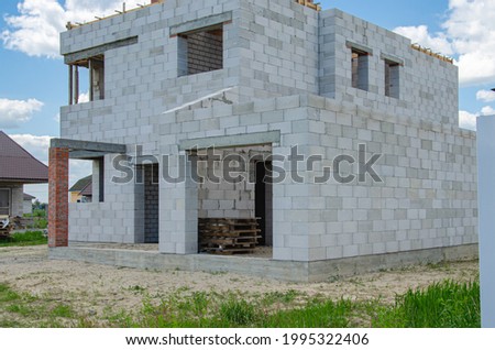 Building site of a house under construction made from white foam blocks. Building new frame of home. Royalty-Free Stock Photo #1995322406
