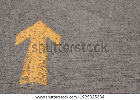 Yellow arrow direction sign on road surface