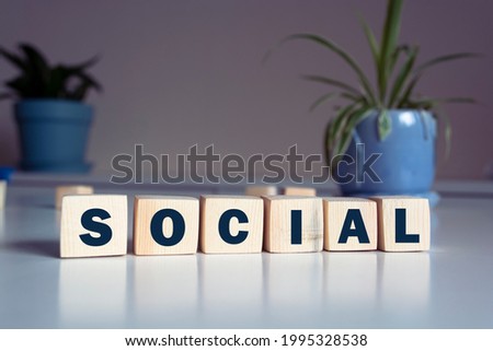 SOCIAL word concept written on wooden cubes blocks lying on a light table and light background