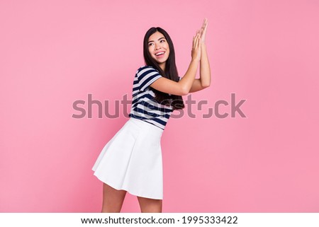 Photo of adorable cute woman wear striped outfit dancing clapping hands arms empty space smiling isolated pink color background
