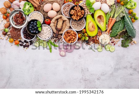 Ingredients for the healthy foods selection. The concept of superfoods set up on white shabby concrete background with copy space. Royalty-Free Stock Photo #1995342176