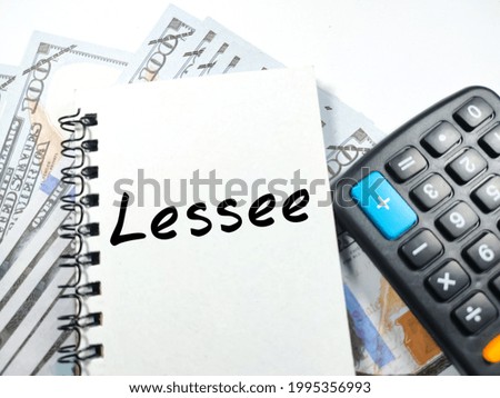 Business concept. Text Lessee on notebook with calculator and banknote on white background.