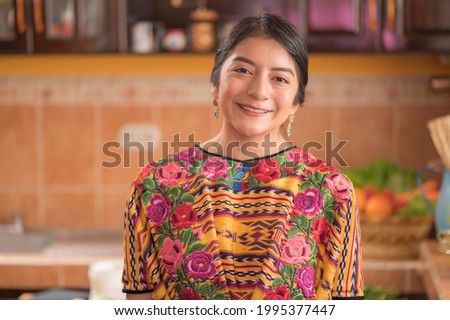 Portrait of an indigenous woman looking at camera smiling and happy. Royalty-Free Stock Photo #1995377447