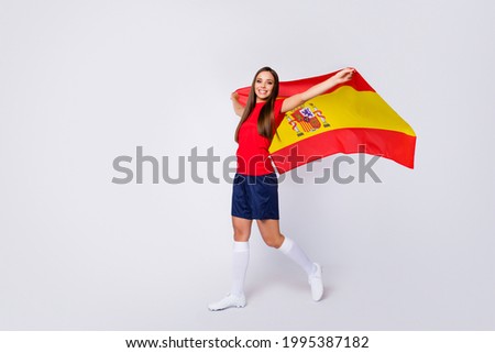 Full body profile photo of joyful fun cheerful lady support soccer team 2020 league hold spain national flag final game wear football uniform t-shirt shorts cleats socks isolated white background