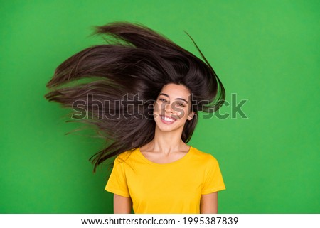 Photo of positive young charming woman fly hair hairstyle smile good mood isolated on green color background