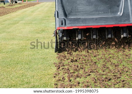 Pile of plugs of soil removed from sports field. Waste of core aeration technique used in the upkeep of lawns and turf Royalty-Free Stock Photo #1995398075