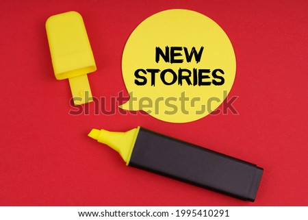 Business concept. On a red background is a marker and a sticker with the inscription - New Stories