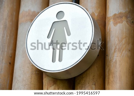 female toilet. The female symbol represents the women's restroom. female symbol on a silver circle background