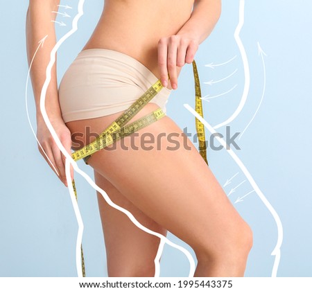 Young woman with measuring tape after weight loss on color background Royalty-Free Stock Photo #1995443375