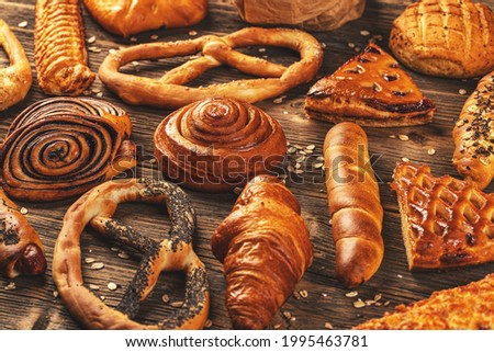 Assortment of tasty sugary bakery products in variety flavor on wooden background