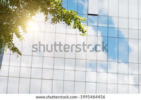 Clouds reflected in modern office building wall.