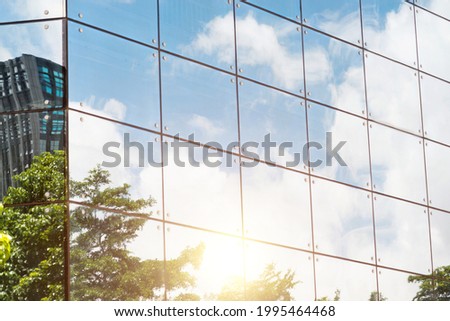 Clouds reflected in modern office building wall.