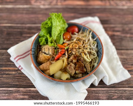 Tofu Soup (Tahu Campur - Indonesia) is a food street from Surabaya, East Java Indonesia. It is made from beef meat stock, served with yellow noodle, tofu, chilli shrimp paste and vegetables.  
