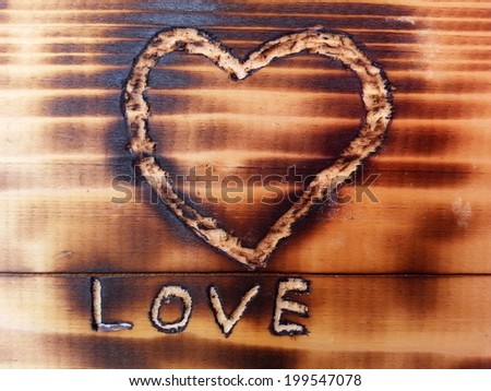 Love text and Heart sign Carved in Sooty Wooden Board