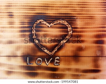 Love text and Heart sign Carved in Sooty Wooden Board