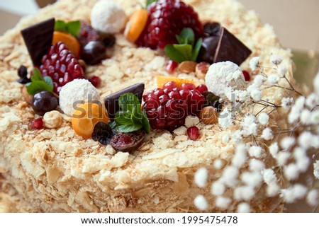 Beautiful bright, homemade honey cake with fruits and sweets. High quality photo