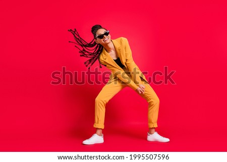 Full size photo of cute lady dance wear eyewear yellow suit isolated on vivid red color background