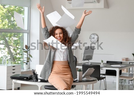 Happy businesswoman before weekends in office Royalty-Free Stock Photo #1995549494