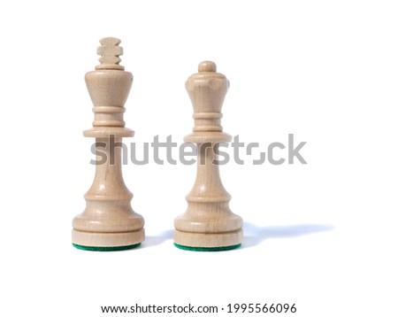 White wooden chess king and queen on a white background. Isolated. Royalty-Free Stock Photo #1995566096