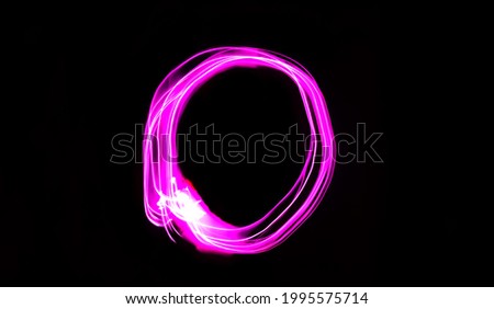 Neon letter O, pink long exposure light writes O, light painting, isolated black background.