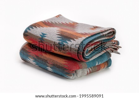 Several luxurious multi-colored throw wool blanket. Elegant textile background in Pendelton style.