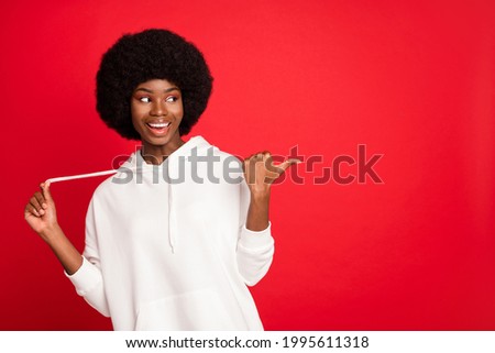 Photo of impressed brunette millennial lady point look empty space wear white sportswear isolated on red color background