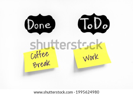 Chalk text Done, ToDo on black labels. Concept learn, starting education. Two Yellow stickers with Coffee Break and Work text on white Whatman paper. Handwriting text close up, copy space Royalty-Free Stock Photo #1995624980