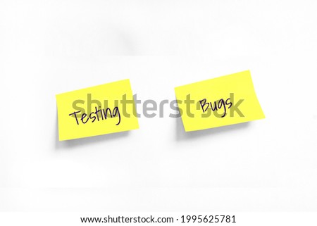 Testing and Bugs Handwriting text on two Yellow stickers on white Whatman paper. Concept of learning, work, programming, testing, business. Handwriting text, copy space Royalty-Free Stock Photo #1995625781