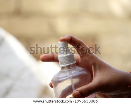 photography of hand holding spray.