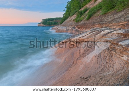 Summer landscape of the eroded sandstone shoreline of Lake Superior at twilight, Pictured Rocks National Lakeshore, Michigan’s Upper Peninsula, USA