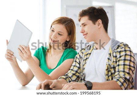 education, technology and internet concept - smiling students with tablet pc computers at school