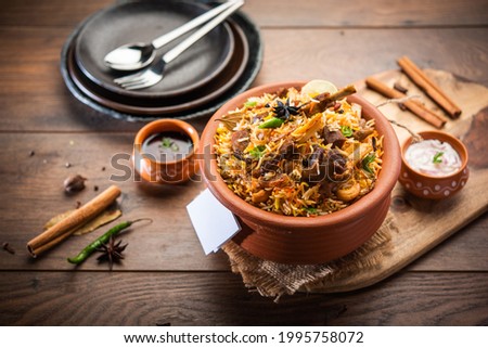 Dum Handi Mutton Biryani or gosht pilaf is prepared in an earthen or clay pot called Haandi or 1 kilo size. Popular Indian non vegetarian food Royalty-Free Stock Photo #1995758072