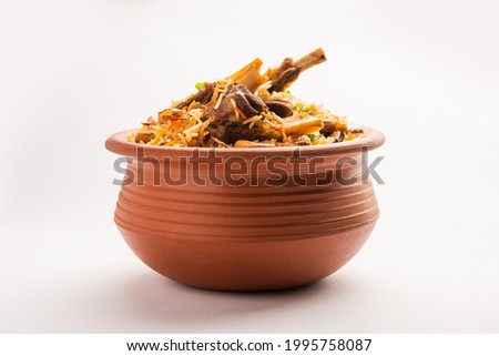 Dum Handi Mutton Biryani or gosht pilaf is prepared in an earthen or clay pot called Haandi or 1 kilo size. Popular Indian non vegetarian food Royalty-Free Stock Photo #1995758087