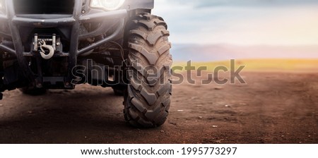 Banner ATV wheels quad bike on desert offroad dust.