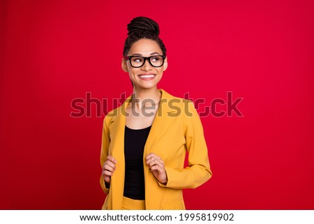 Photo of pretty business lady look empty space touch cardigan wear eyewear isolated on vivid red color background