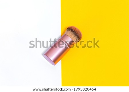 Make up brush powder blusher isolated on colorful background and selective focus. Blush is the perfect accessory for women's makeup all over the world. Cosmetic and make up concept. Fashion concept.