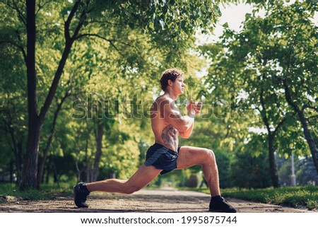 young fitness man runner stretching legs before run. 