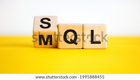 SQL or MQL symbol. Turned wooden cubes and changed words 'MQL marketing qualified lead' to 'SQL sales qualified lead'. Beautiful white background. Business and SQL or MQL concept. Copy space. Royalty-Free Stock Photo #1995888455