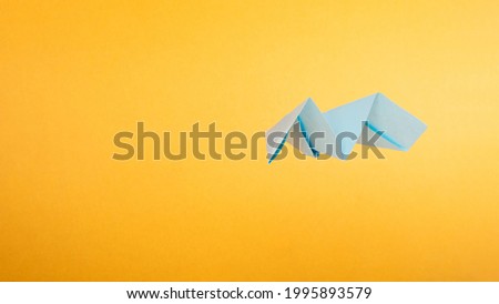 paper blue airplane on yellow background travelling concept, Ukrainian airspace.