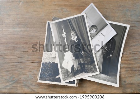 old vintage monochrome photographs of 1940-1950 in sepia color are scattered on a wooden table, the concept of genealogy, the memory of ancestors, family ties, memories of childhood