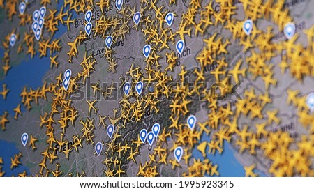 Busy air traffic over map of Europe, time lapse with many routes of commercial airplanes Royalty-Free Stock Photo #1995923345