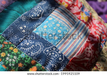 Close up patchwork. Photo shows quilting concept. Royalty-Free Stock Photo #1995925109