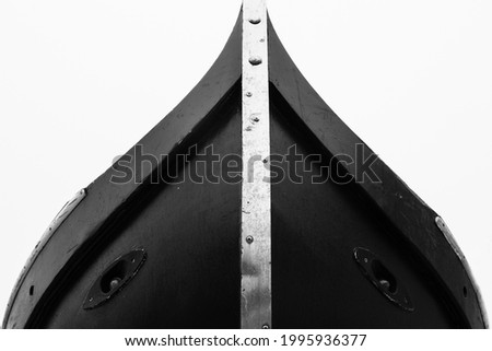The detail of a gondola in Venice shows a face in black and white