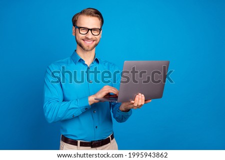 Photo of young business man happy positive smile programmer work project isolated over blue color background
