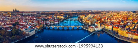 Aerial Prague panoramic drone view of the city of Prague at the Old Town Square, Czechia. Prague Old Town pier architecture and Charles Bridge over Vltava river in Prague at sunset, Czech Republic.  Royalty-Free Stock Photo #1995994133