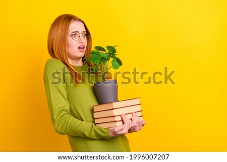 Profile photo of impressed orange hairdo young lady hold books plant wear green sweater spectacles isolated on yellow color background