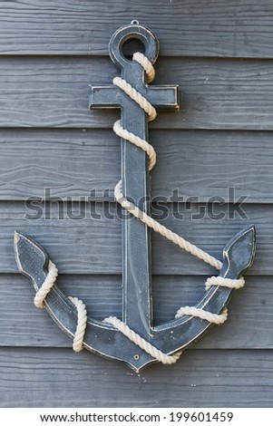 The Old wooden anchor on wood wall background
