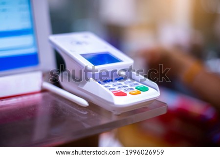 Selective focus to electronic pen with touch screen of credit card sale transaction receipt machine at supper market. Electronic signature concept.