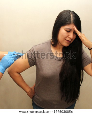 30-year-old Latin woman happy and scared with the Covid-19 vaccine shot
