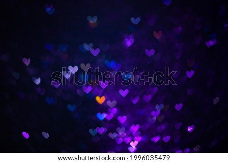 Decoration twinkle glitters background, abstract shiny backdrop with hearts, modern design overlay with sparkling glimmers. Purple, blue and orange backdrop glittering sparks with glow effect.